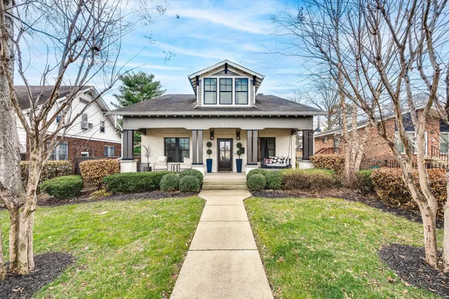 a lobby with furniture and potted plants