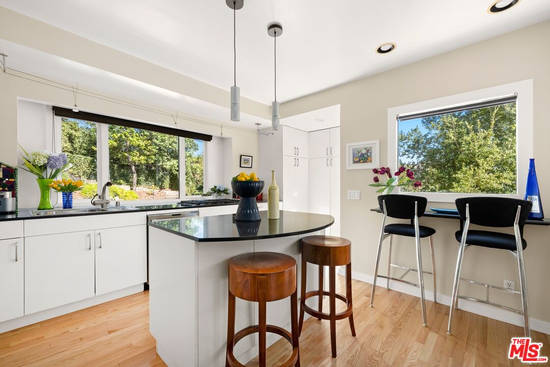 680 Glenmore Boulevard Glendale, CA 91206 - Photo 8 of 15 a kitchen with stainless steel appliances kitchen island wooden cabinets and dining table