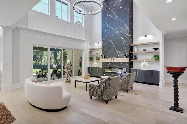 a living room with furniture and a floor to ceiling window