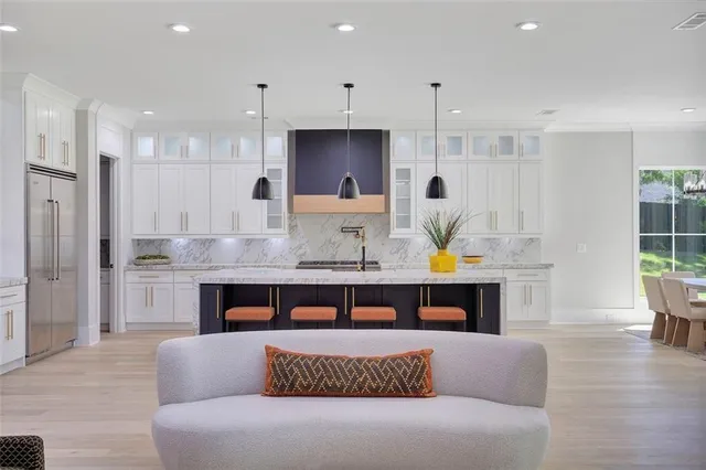 a kitchen with white cabinets a sink and a stove