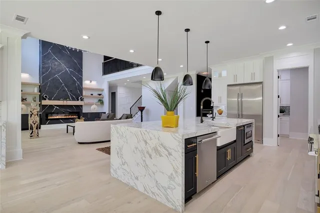 a spacious bedroom with a bed and a chandelier