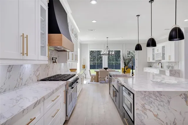a kitchen with a sink dishwasher a refrigerator and cabinets