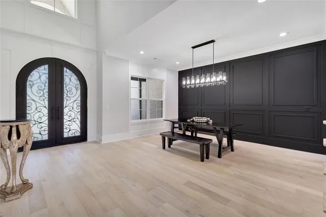 a living room with furniture a fireplace and a chandelier