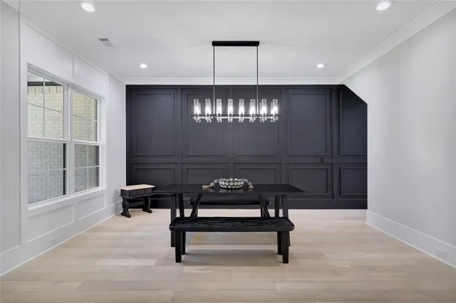 a living room with furniture a fireplace and a dining table with wooden floor