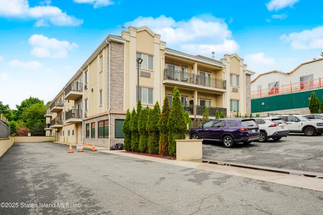 a couple of cars parked in front of a building