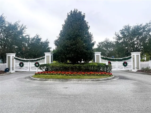 a front view of a house with a garden and plants