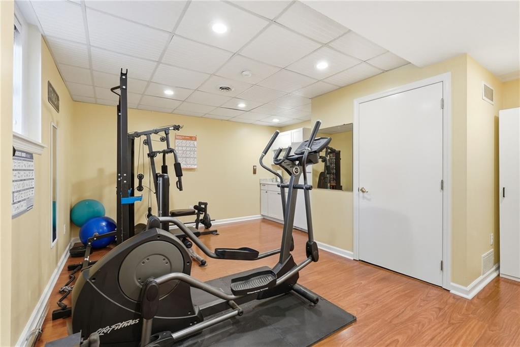 900 Settlers Ridge Road Pittsburgh, PA 15238 - Photo 35 of 50 Enjoy a dedicated lower-level fitness area with views of the patio and pool, conveniently positioned near the kitchenette. Select exercise equipment may be available.