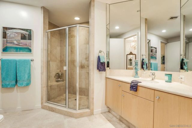 a bathroom with a shower sink and mirror