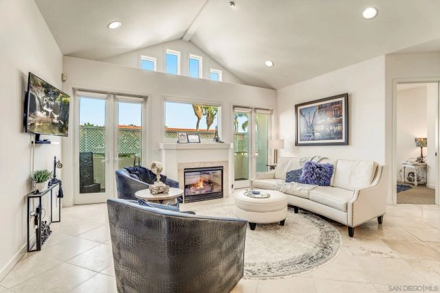 a living room with furniture a large window and a fireplace
