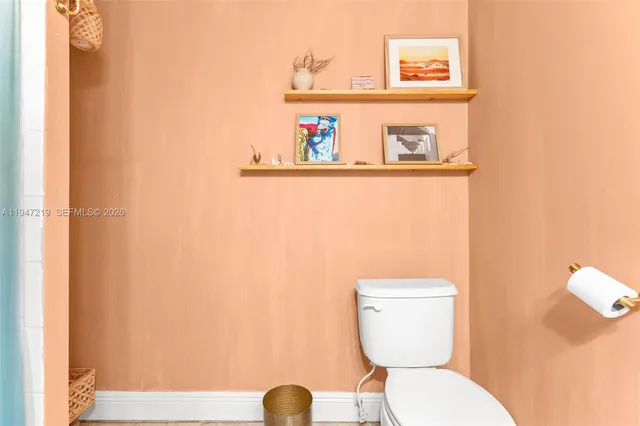 a white toilet sitting next to a sink