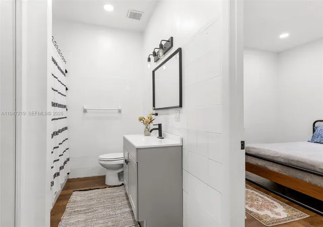 a bathroom with a sink toilet and shower