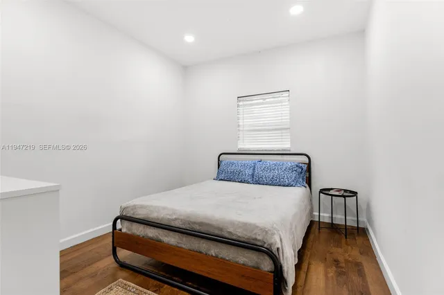 a bedroom with a bed and a night stand