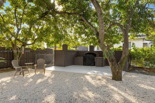 a view of a chairs and table in backyard