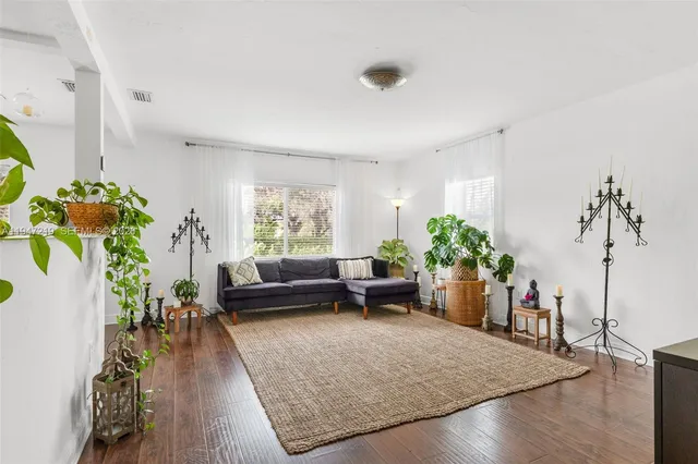 a living room with furniture and a potted plant