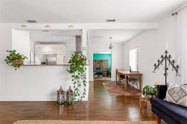 a living room with furniture dining room and wooden floor