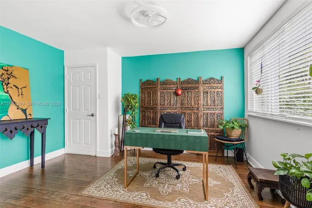 a living room with furniture and a floor to ceiling window