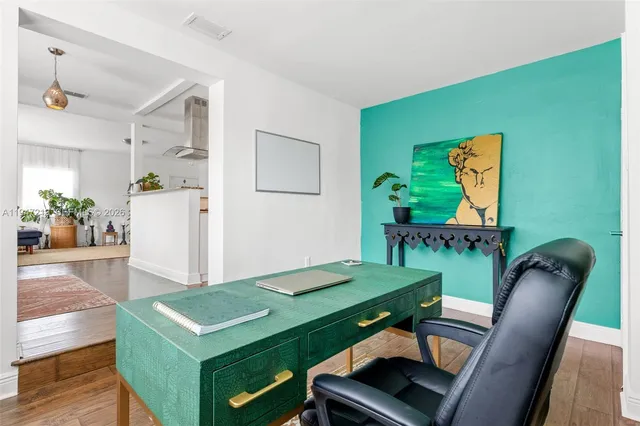 a view of a room with furniture and wooden floor
