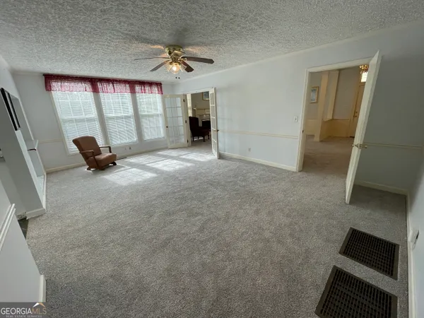 a living room with a baby crib furniture and a window