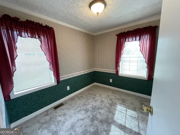 a view of an empty room and a window