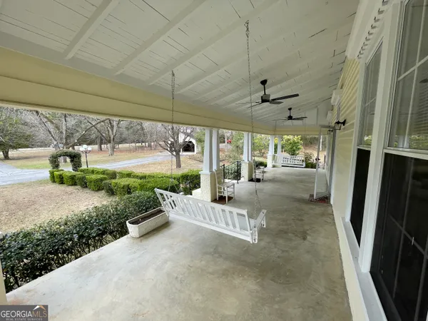 a view of a backyard with sitting area
