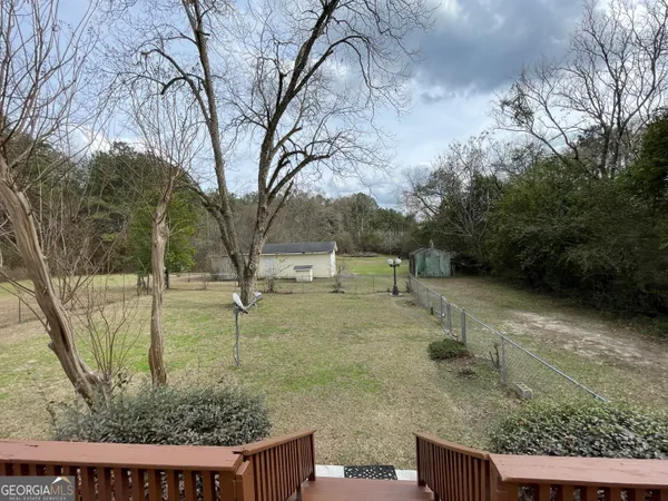 a view of a house with large trees
