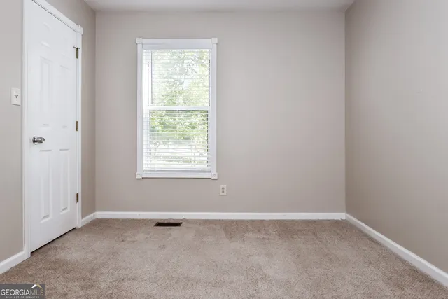 a bathroom with a granite countertop sink toilet a mirror and shower