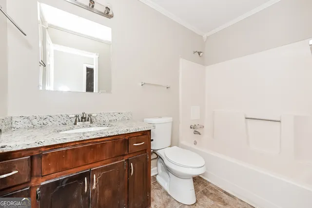 a view of a chair and table in backyard of the house