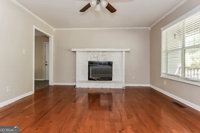 wooden floor fireplace and natural light in room