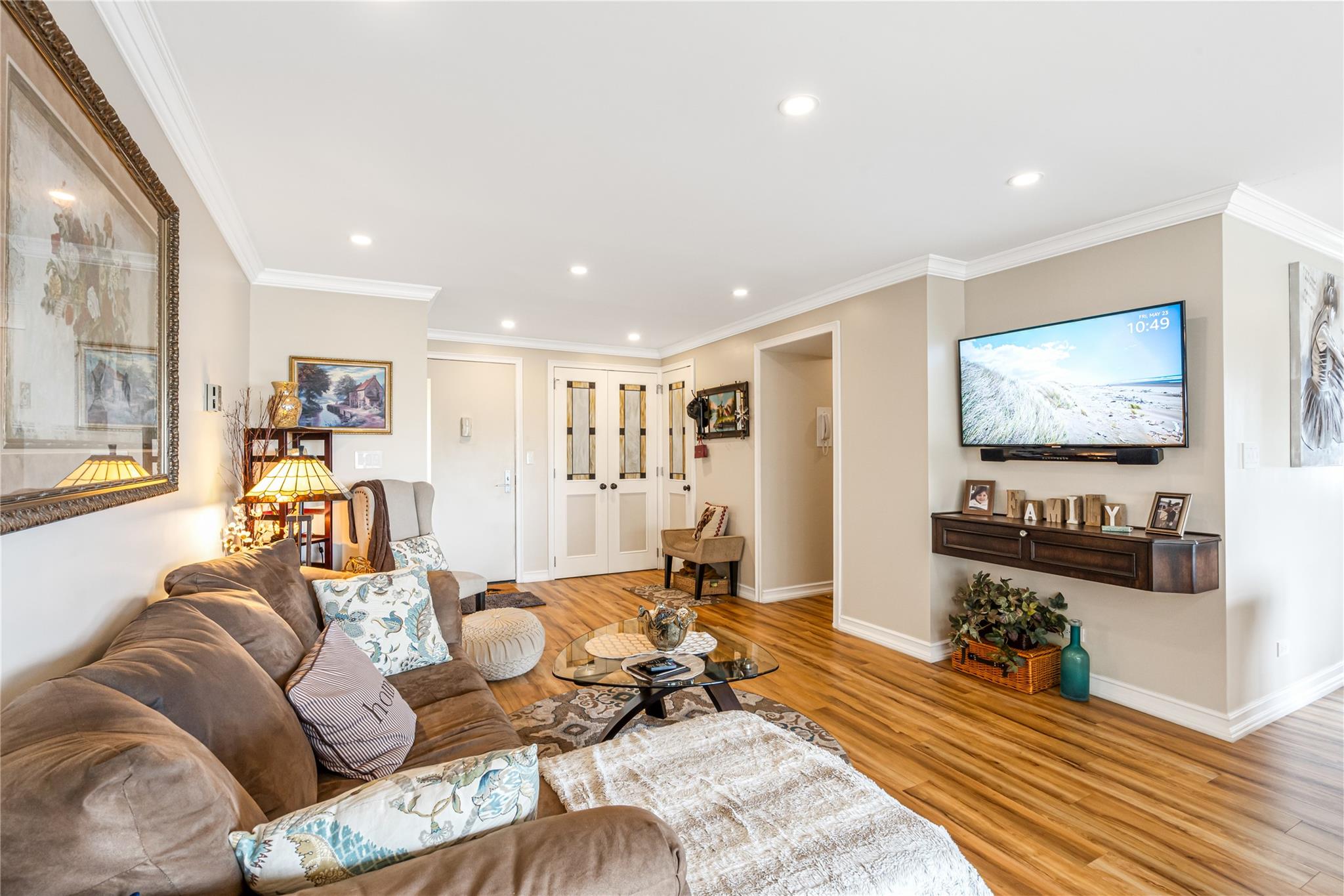 17-85 215th Street, Unit 4M Queens, NY 11360 - Photo 6 of 41 Living room featuring light wood finished floors, recessed lighting, ornamental molding, baseboards, and french doors