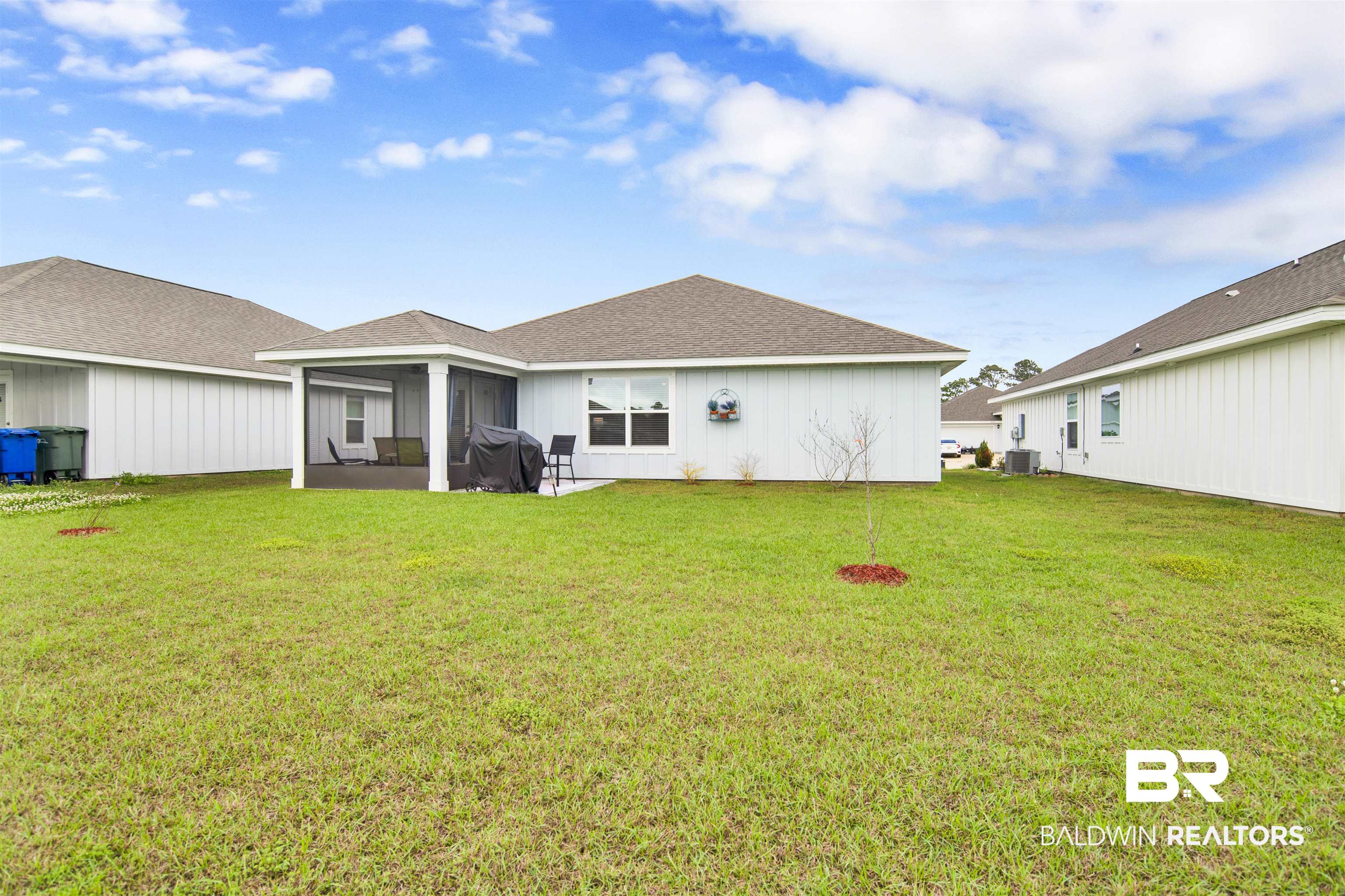 22348 Aleutian Avenue Foley, AL 36535 - Photo 26 of 32 Rear view of property featuring a lawn, roof with shingles, and board and batten siding
