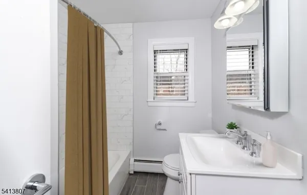a bathroom with a sink a toilet and a mirror