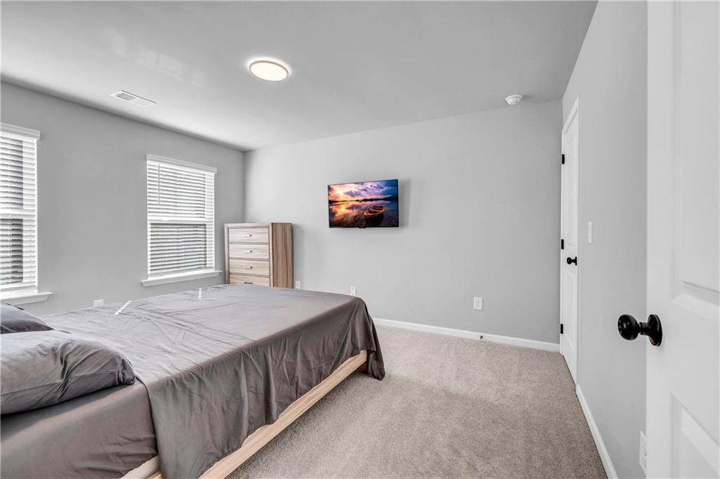 6095 Marigold Way Atlanta, GA 30349 - Photo 13 of 17 a bedroom with a bed and a window