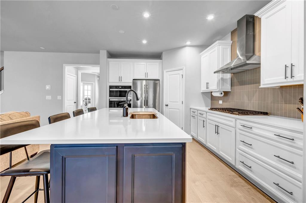 6095 Marigold Way Atlanta, GA 30349 - Photo 4 of 17 a kitchen with kitchen island a sink stove and refrigerator