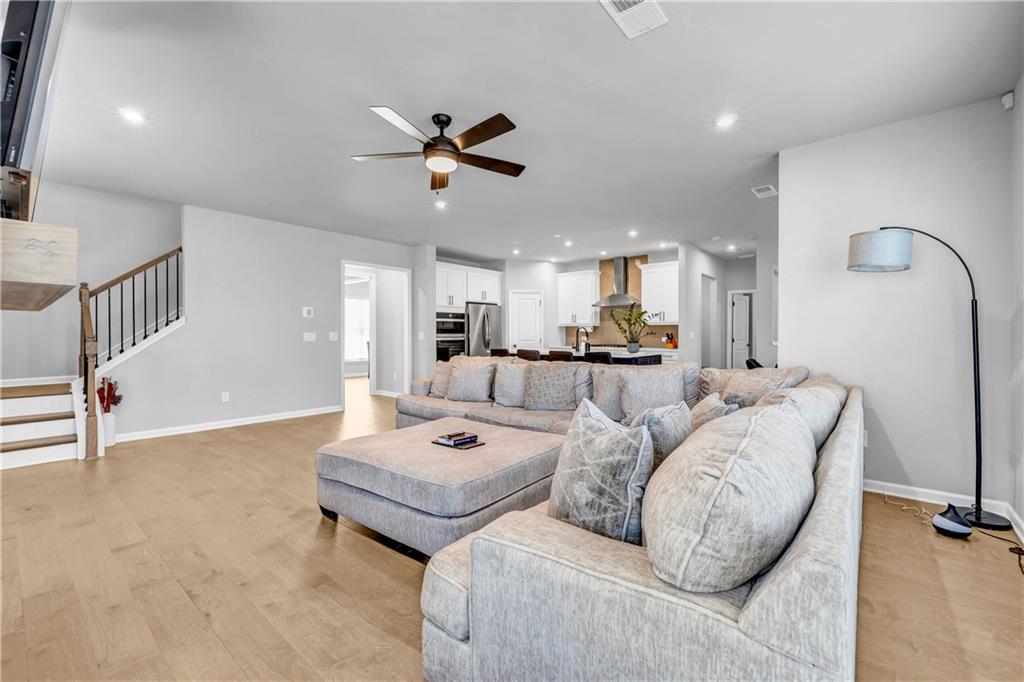 6095 Marigold Way Atlanta, GA 30349 - Photo 7 of 17 a living room with furniture and a wooden floor