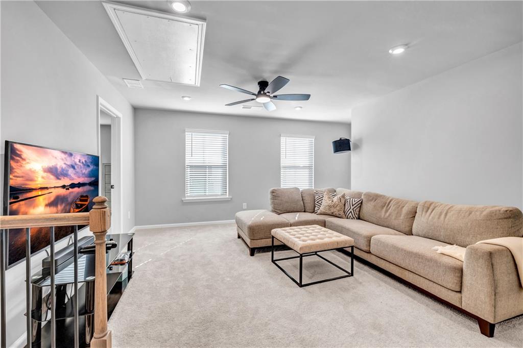 6095 Marigold Way Atlanta, GA 30349 - Photo 8 of 17 a living room with furniture and a flat screen tv