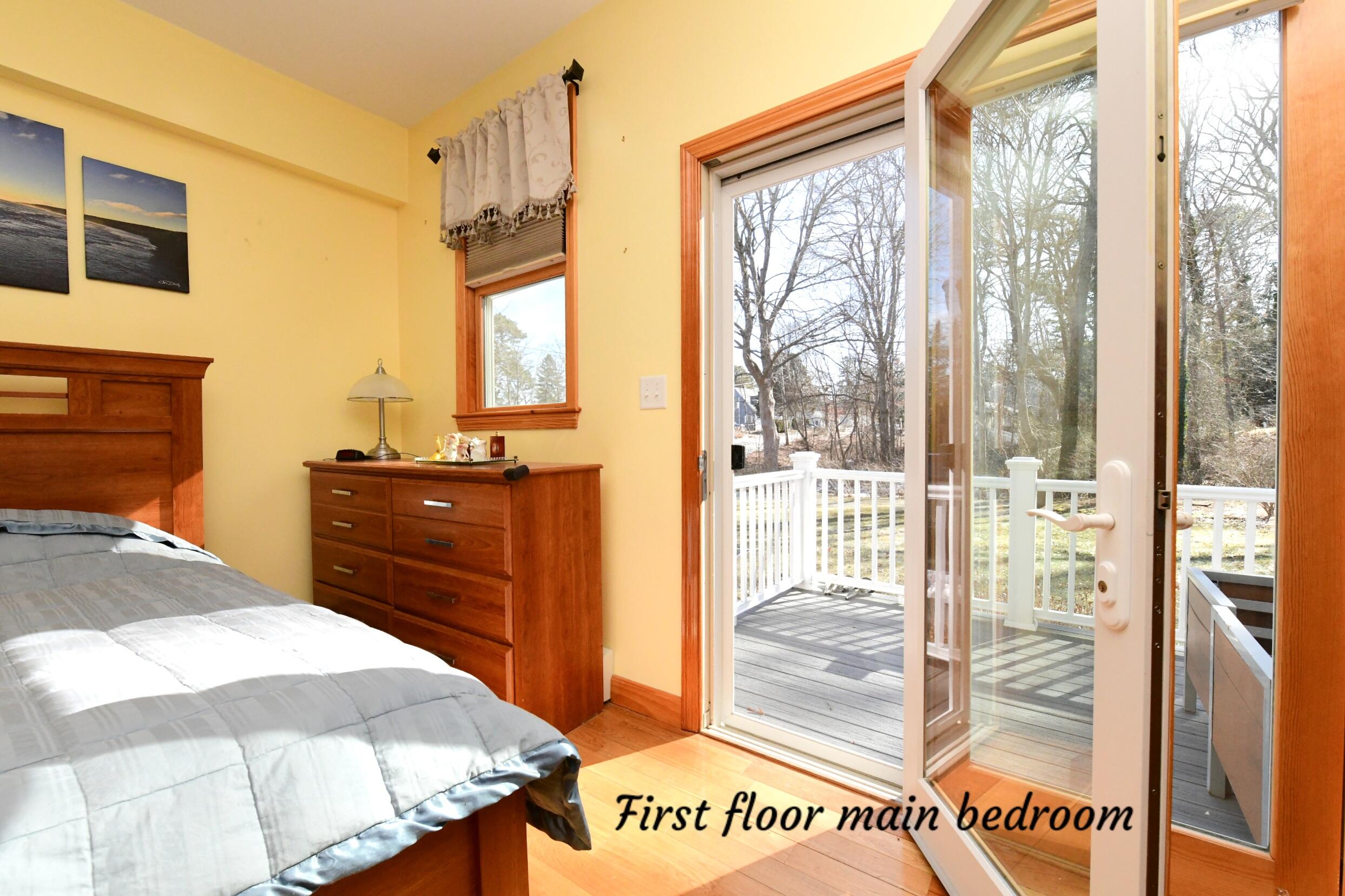 173 Standish Road Sagamore Beach, MA 02562 - Photo 11 of 39 a bedroom with a bed and a dresser next to a window