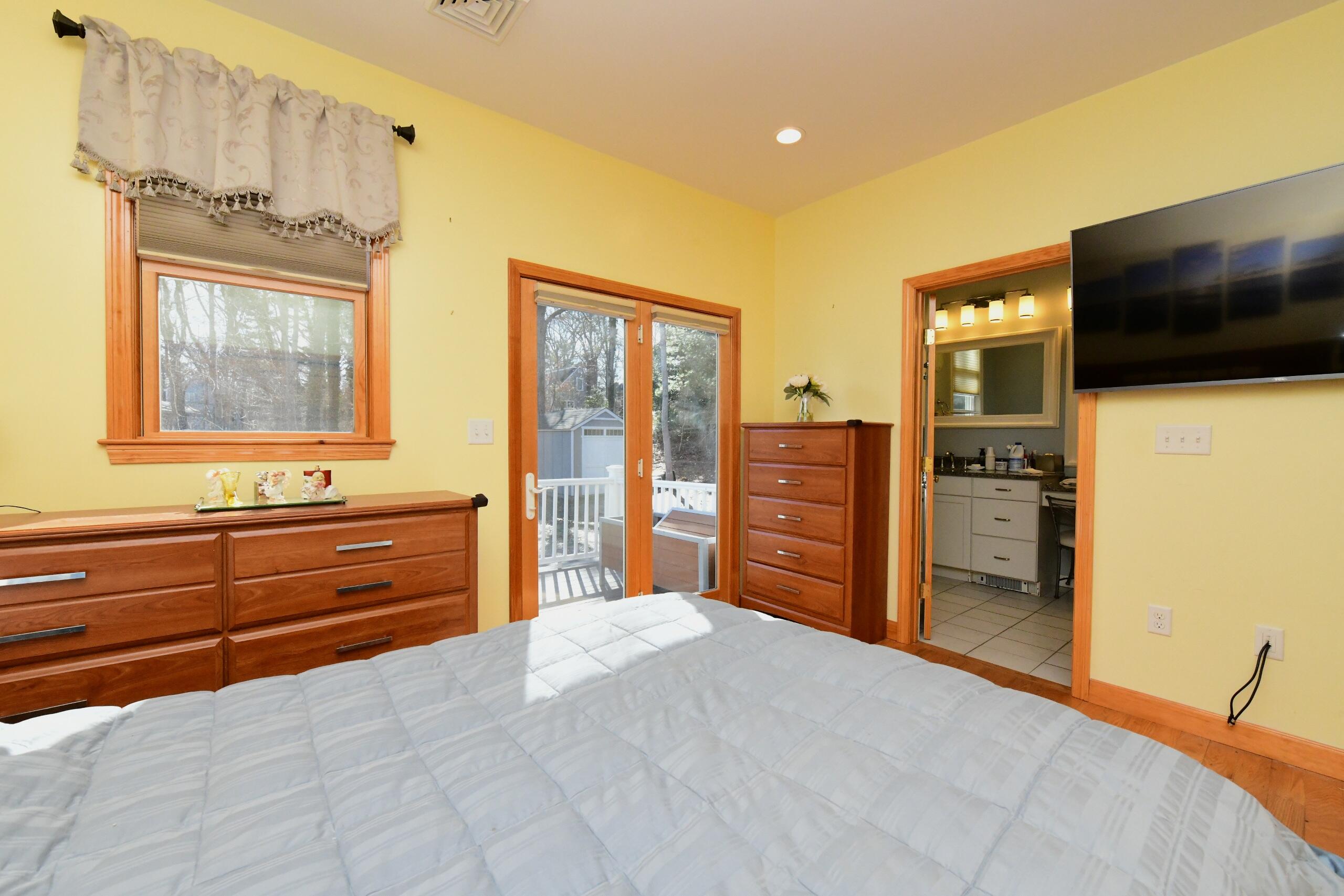 173 Standish Road Sagamore Beach, MA 02562 - Photo 12 of 39 a bedroom with a bed and flat screen tv