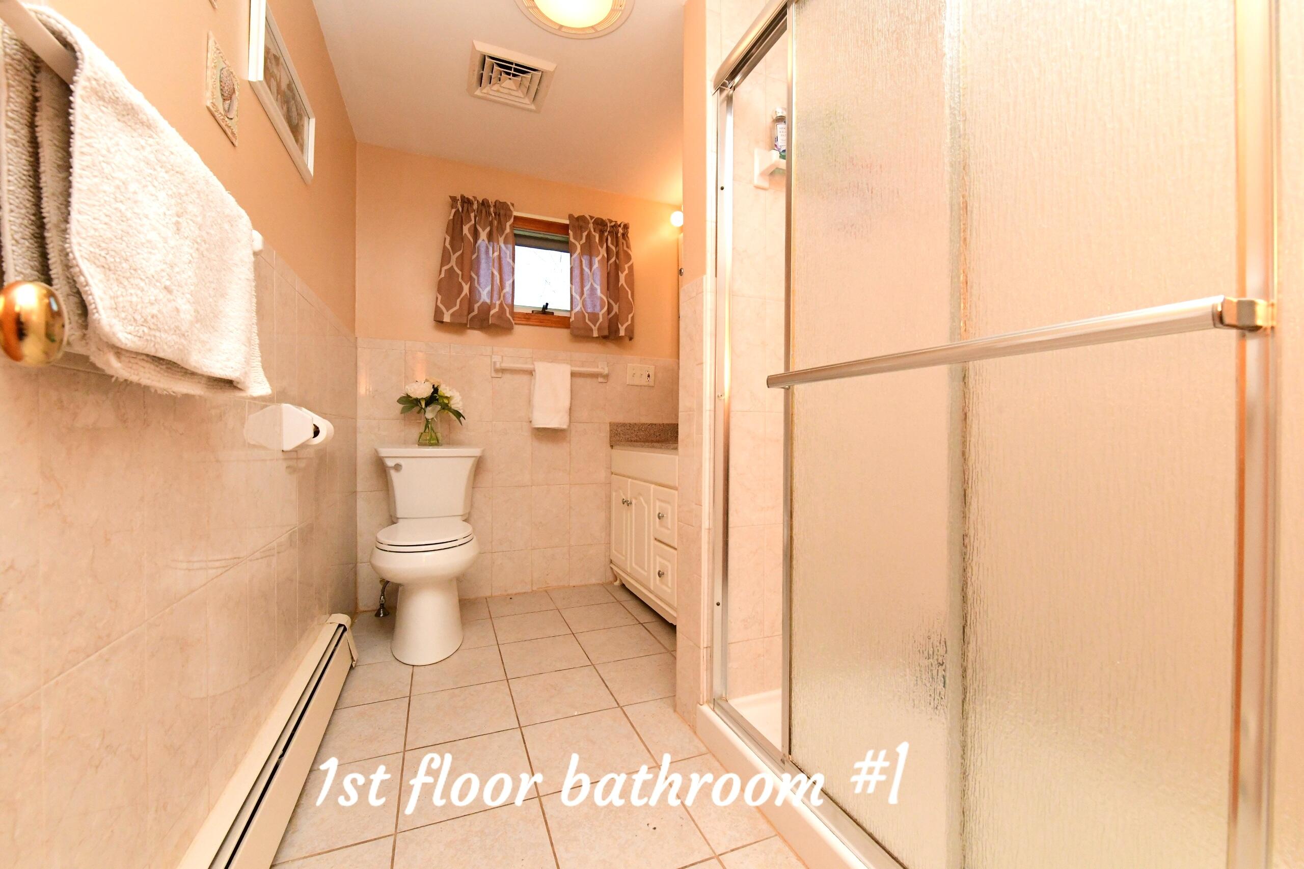 173 Standish Road Sagamore Beach, MA 02562 - Photo 16 of 39 a bathroom with a toilet sink and a mirror