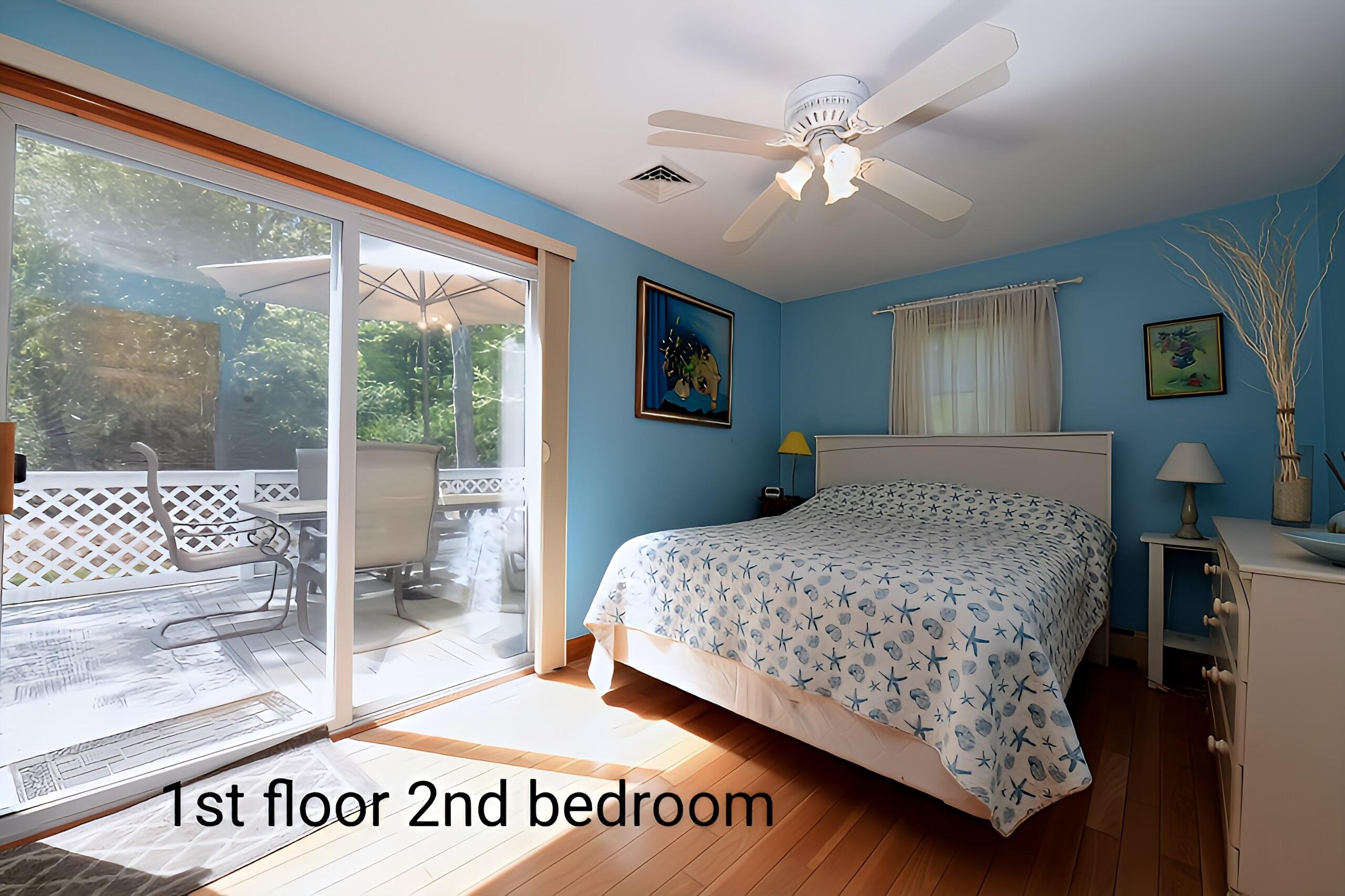 173 Standish Road Sagamore Beach, MA 02562 - Photo 17 of 39 a bedroom with a large bed and a chandelier