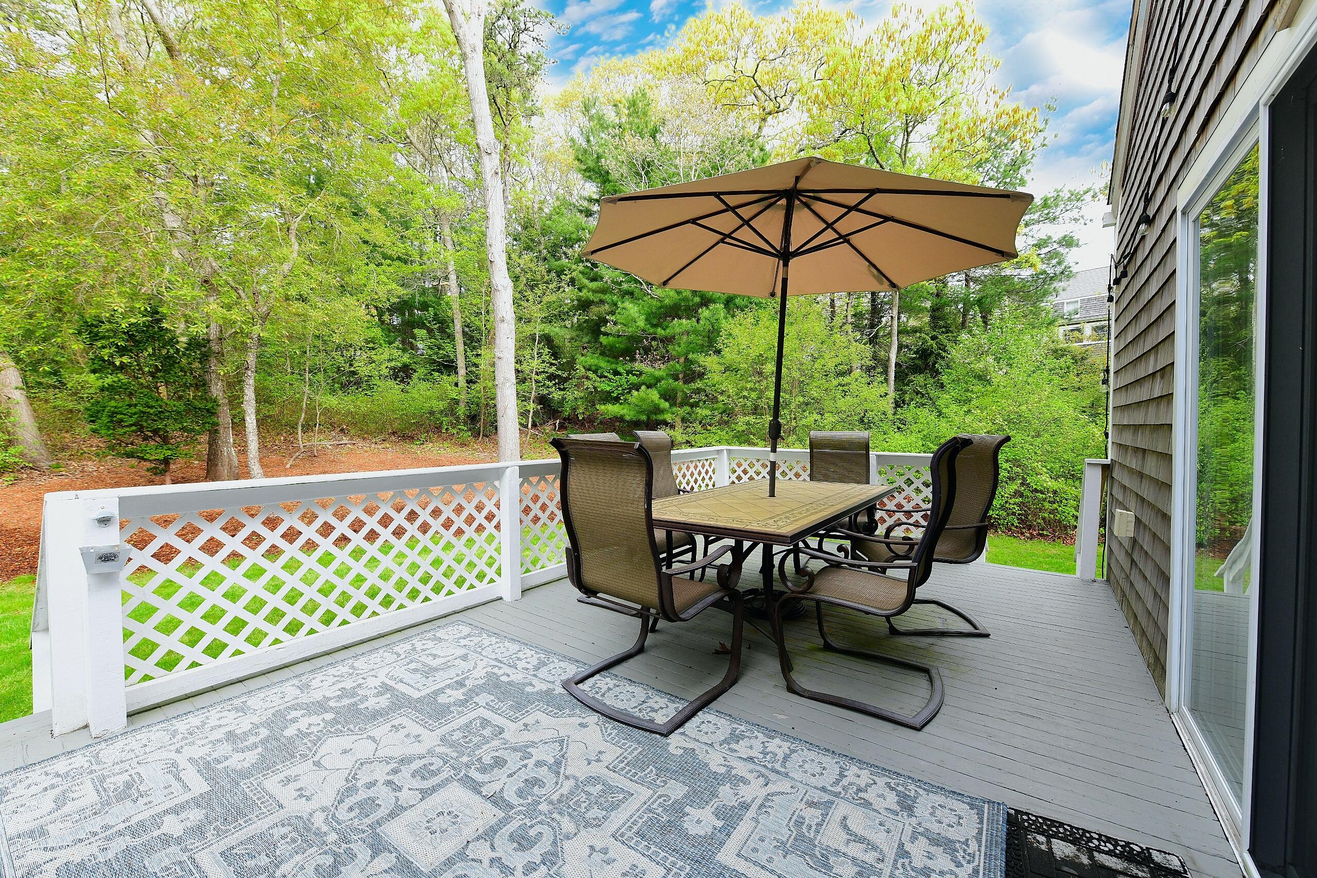 173 Standish Road Sagamore Beach, MA 02562 - Photo 26 of 39 a view of a chairs and table in backyard