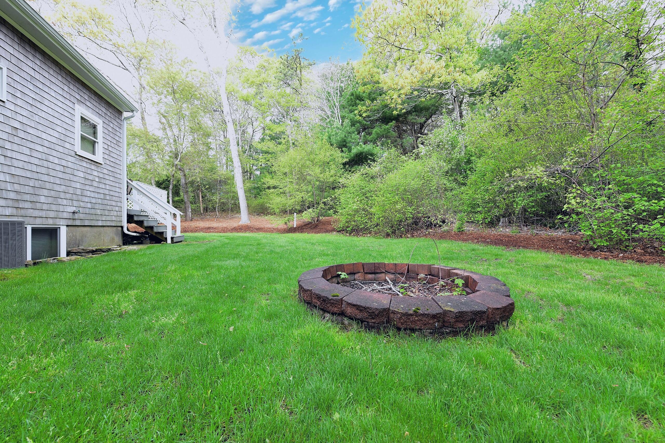 173 Standish Road Sagamore Beach, MA 02562 - Photo 31 of 39 a view of a house with a backyard