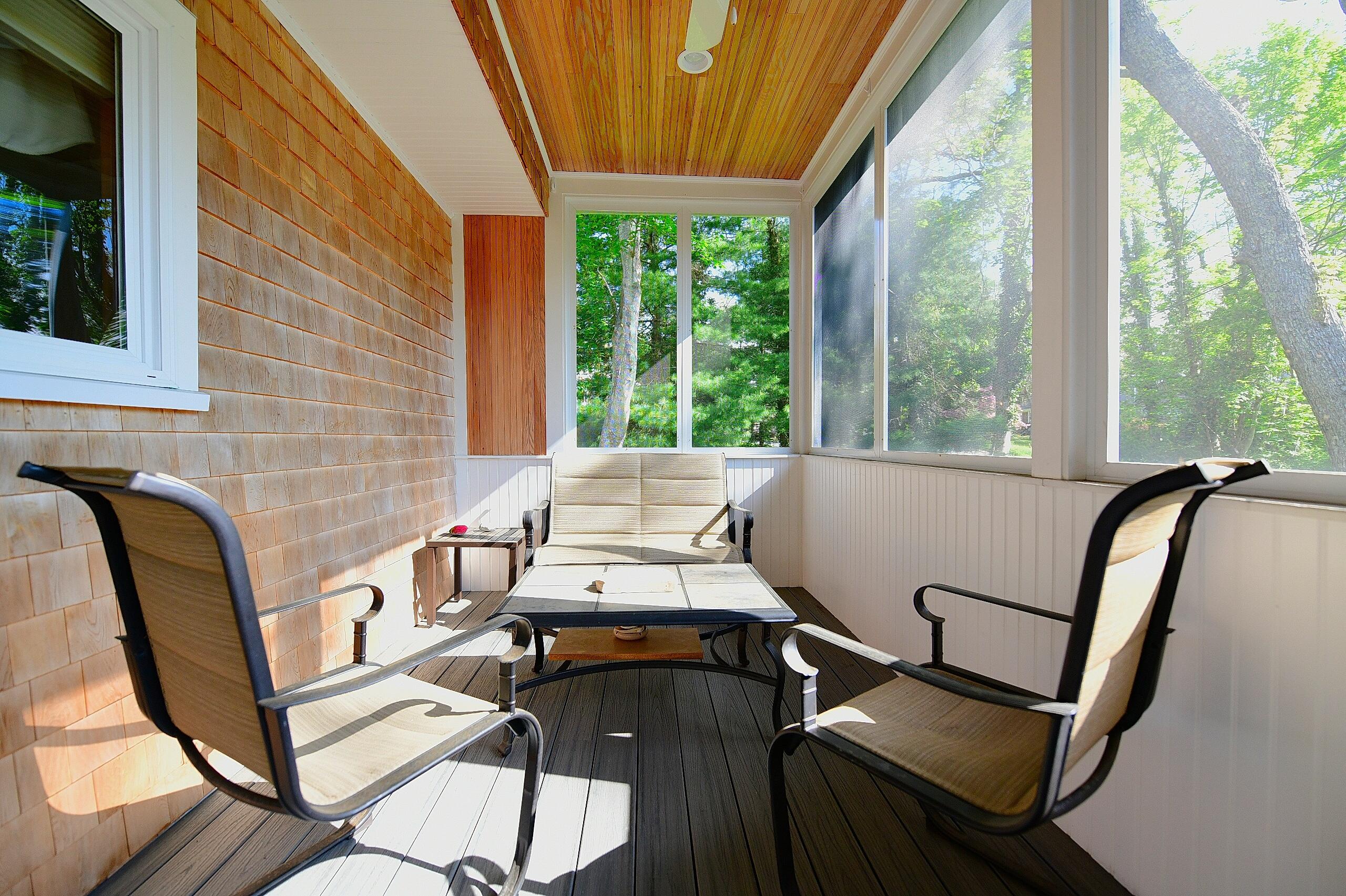173 Standish Road Sagamore Beach, MA 02562 - Photo 6 of 39 a balcony view with a couch and wooden floor