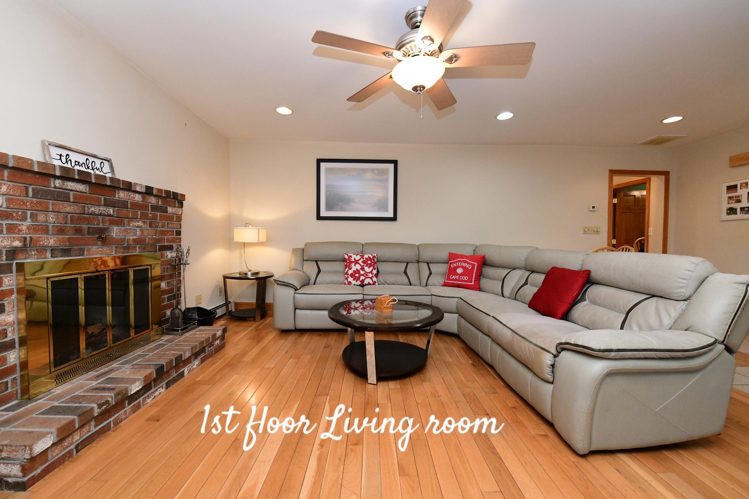 173 Standish Road Sagamore Beach, MA 02562 - Photo 9 of 39 a living room with furniture a fireplace and a flat screen tv