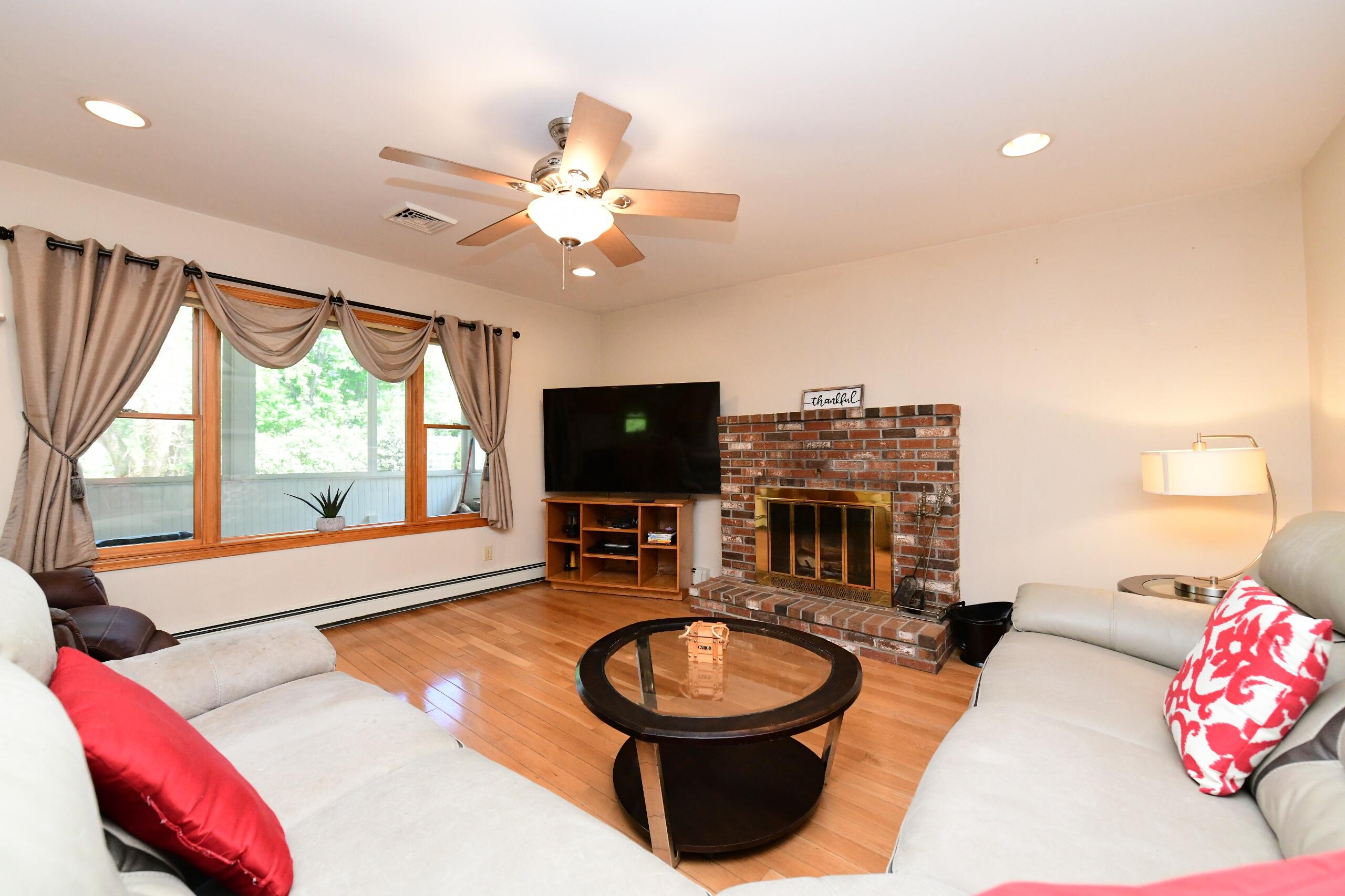 173 Standish Road Sagamore Beach, MA 02562 - Photo 10 of 39 a living room with furniture and a flat screen tv