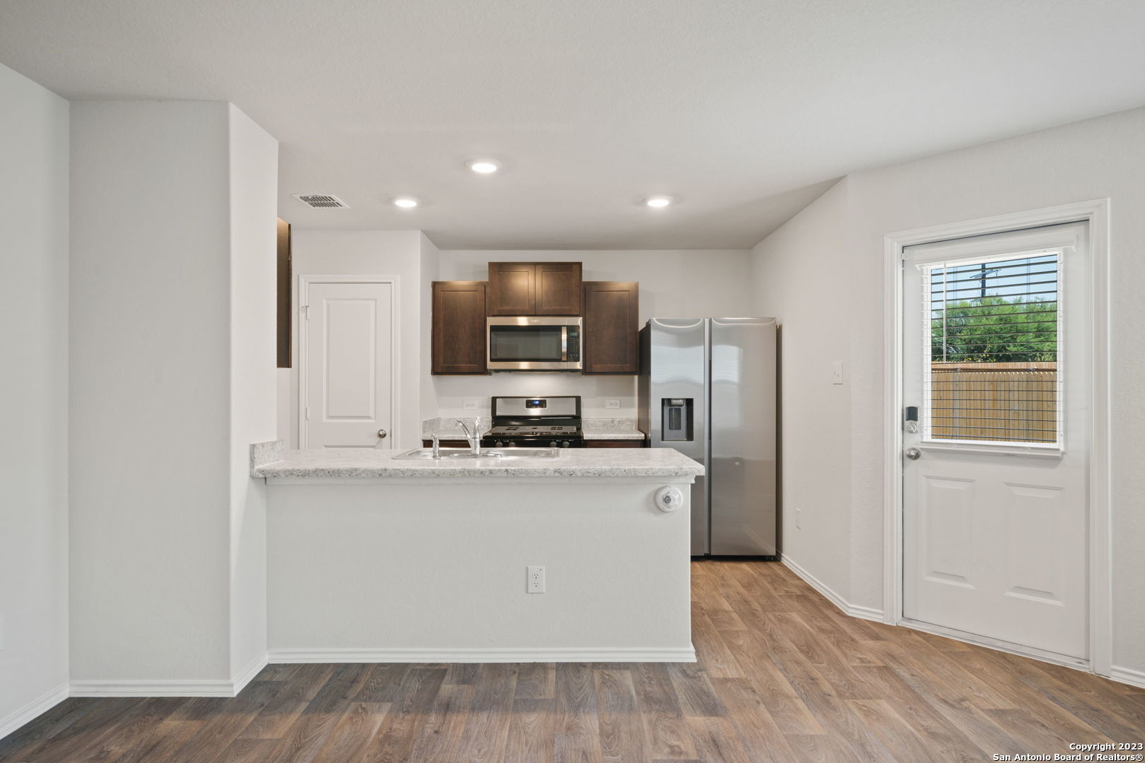 5830 Kendall Prairie Converse, TX 78109 - Photo 11 of 25 a kitchen with stainless steel appliances a refrigerator a stove top oven a sink and dishwasher