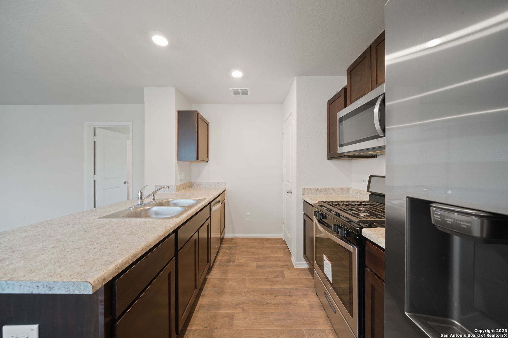 5830 Kendall Prairie Converse, TX 78109 - Photo 12 of 25 a kitchen with stainless steel appliances granite countertop a stove and a sink