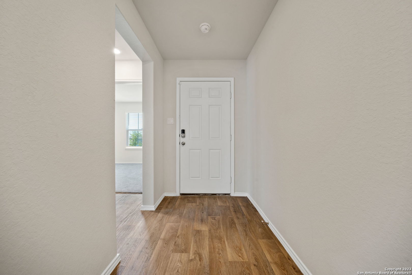 5830 Kendall Prairie Converse, TX 78109 - Photo 5 of 25 a view of a hallway with wooden floor