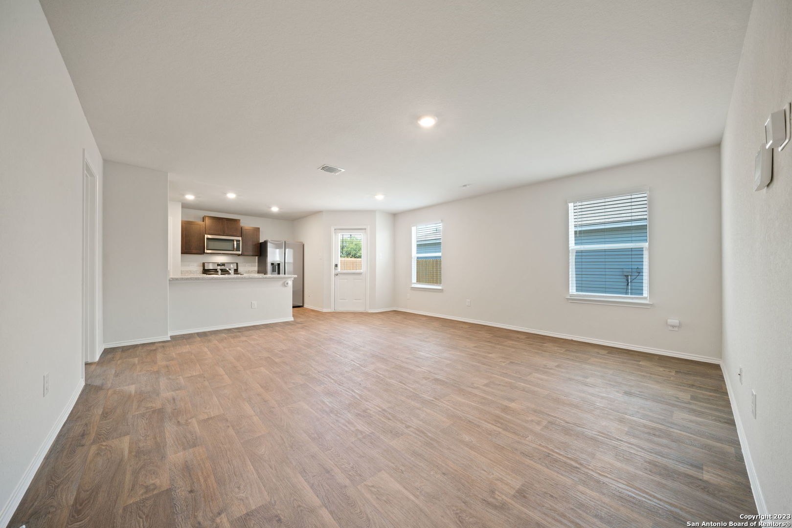 5830 Kendall Prairie Converse, TX 78109 - Photo 6 of 25 a view of an empty room with a window and wooden floor