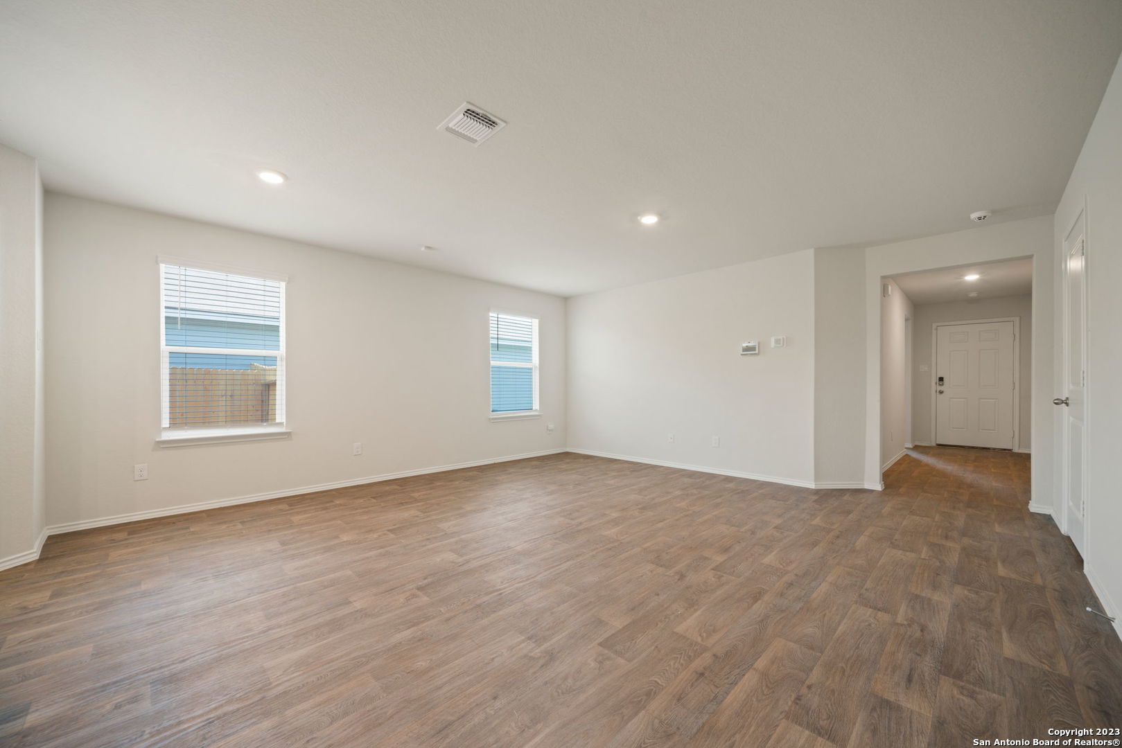 5830 Kendall Prairie Converse, TX 78109 - Photo 7 of 25 a view of an empty room with wooden floor and a window