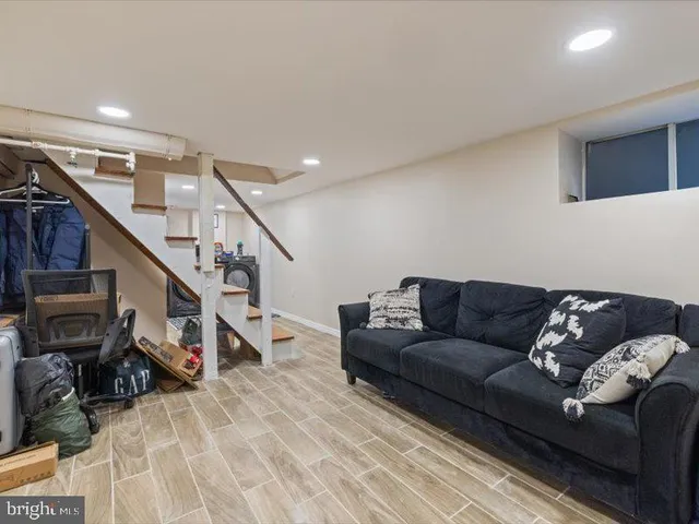 a living room with furniture and stairs